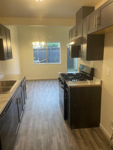 540 South Argyle Avenue, Unit 101 Fresno, CA 93727 - Photo 8 of 11 a kitchen with wooden floors and a stove