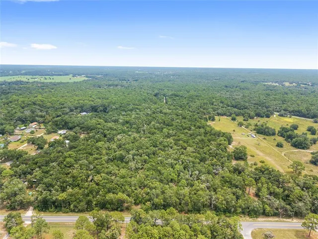 a view of a green field with an outdoor space