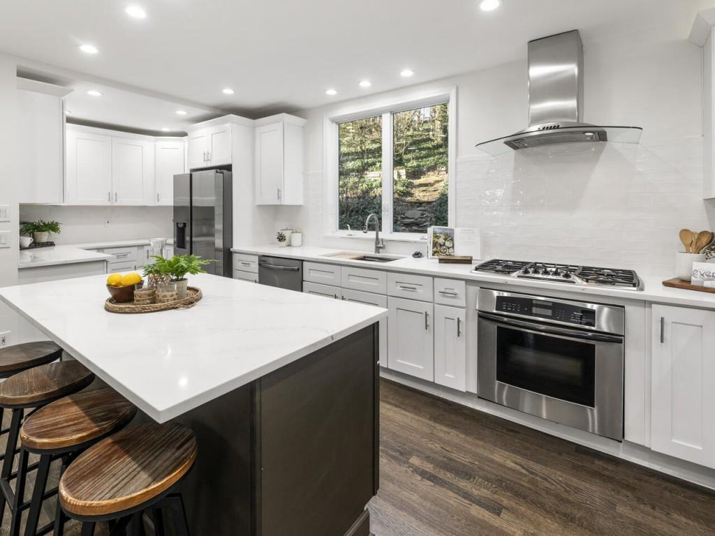 a kitchen with a stove a sink and a refrigerator