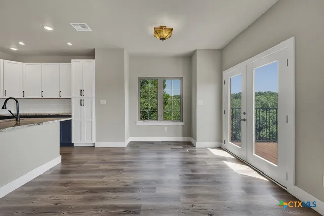 a view of kitchen with wooden floor and electronic appliances
