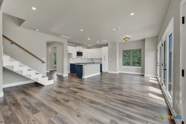 a view of kitchen with cabinets and wooden floor