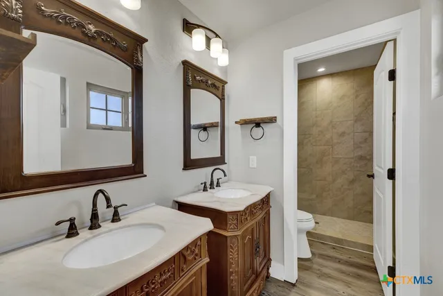 a bathroom with 2 sink and a mirror