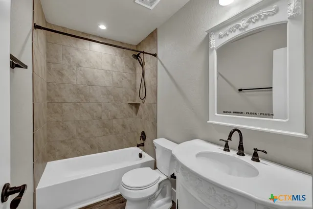 a bathroom with a toilet a sink and a bathtub