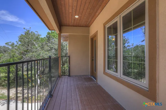 a view of a balcony with wooden floor