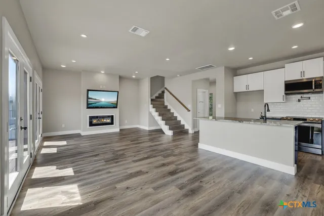 a view of kitchen with sink and refrigerator