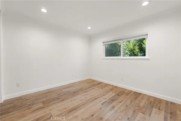 wooden floor in an empty room with window