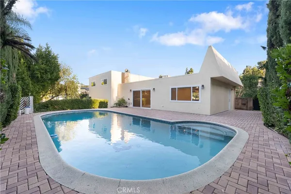 a view of a swimming pool with a yard