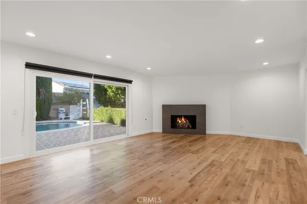 a view of an empty room with a fireplace and a large window