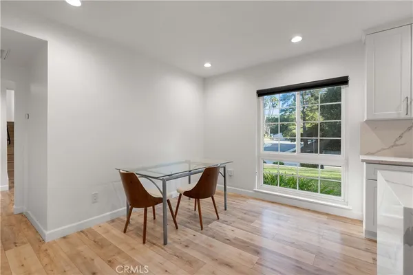 a kitchen with granite countertop a sink cabinets and wooden floor