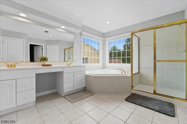 a large bathroom with a tub a sink a mirror and a shower