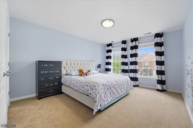 a bedroom with a bed and a book shelf