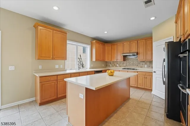 a kitchen with stainless steel appliances granite countertop a sink counter space cabinets and a large window