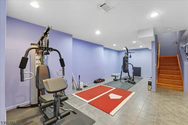 a room with gym equipment and view of gym equipment