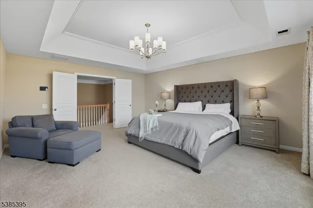 a spacious bedroom with a bed and a couch