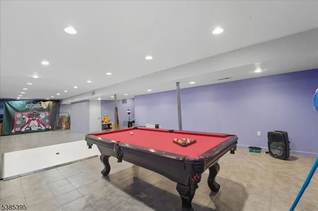 a room with pool table and a flat screen tv