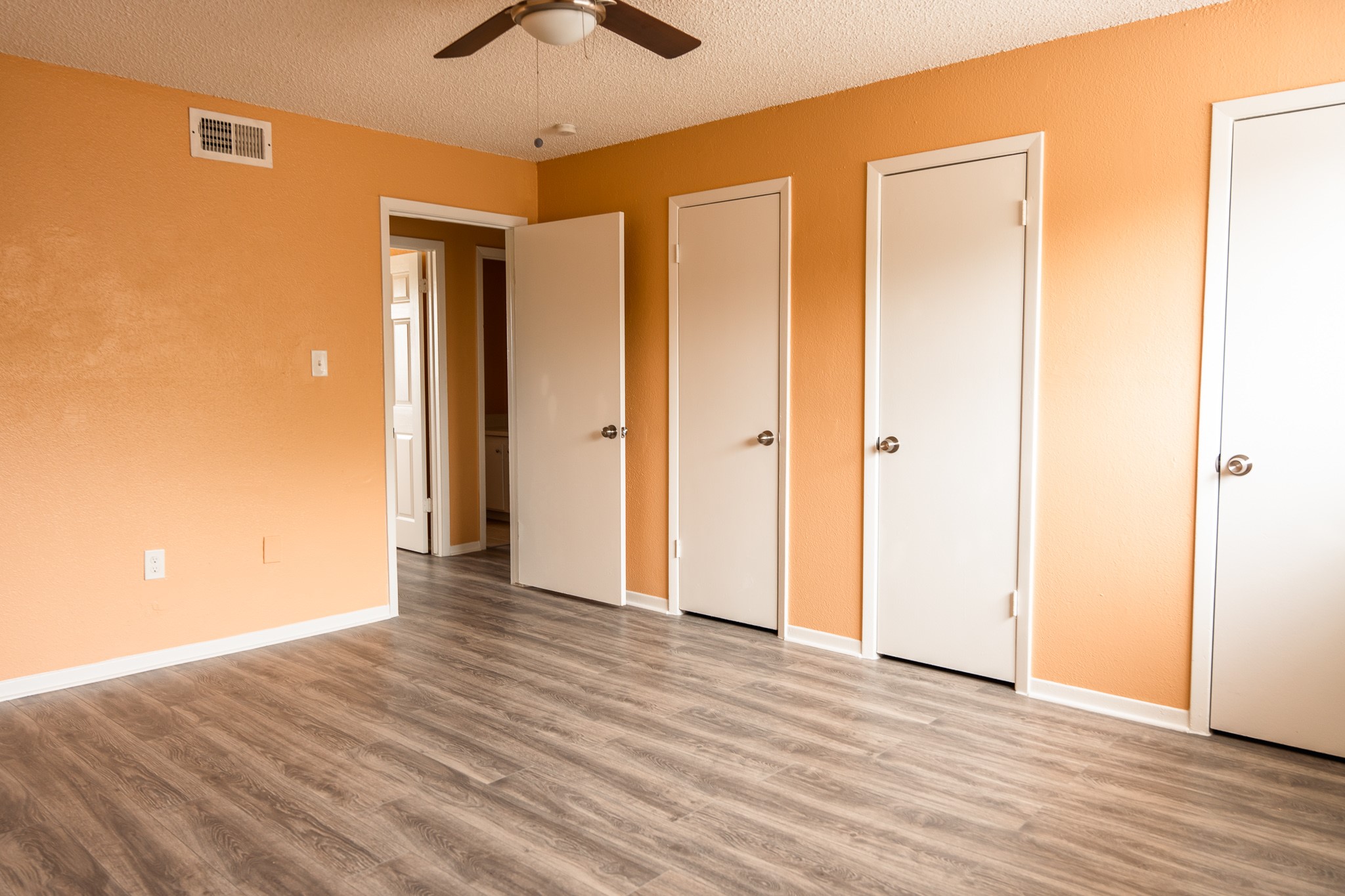 1506 Eagle Lake Road Sealy, TX 77474 - Photo 17 of 17 a view of a livingroom with wooden floor and a ceiling fan