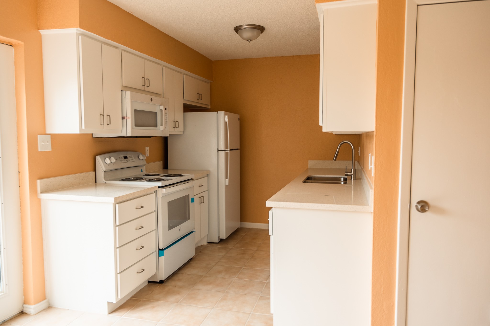 1506 Eagle Lake Road Sealy, TX 77474 - Photo 6 of 17 a kitchen with a refrigerator sink stove and cabinets