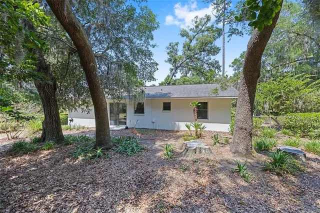a backyard of a house with table and chairs