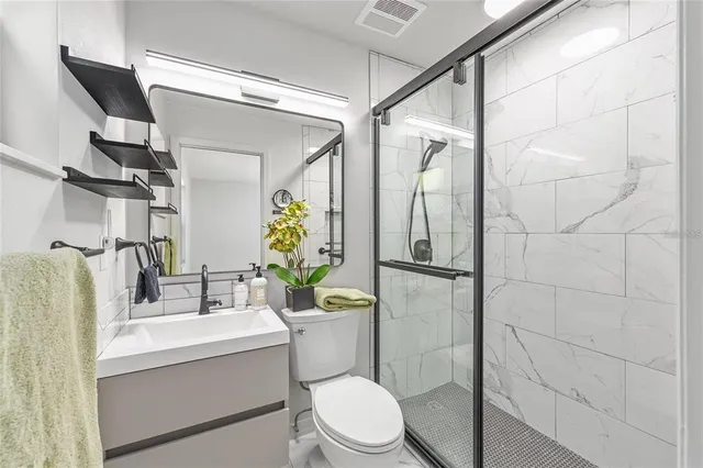 a bathroom with a sink toilet and shower