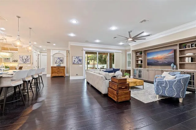 a living room with furniture and a view of kitchen