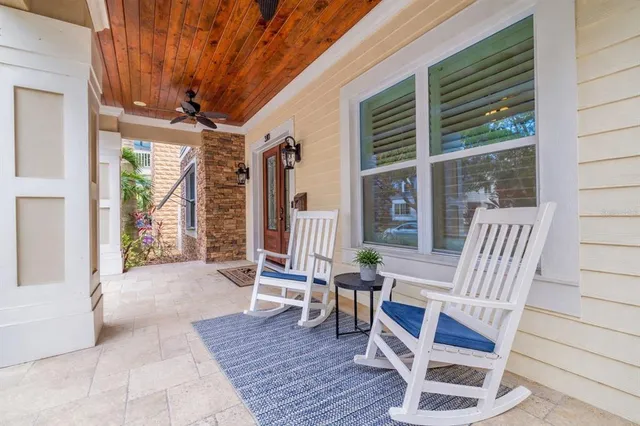 a kitchen with granite countertop a dining table chairs sink and wooden cabinets