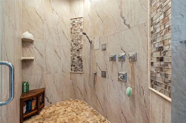 a bathroom with a granite countertop sink a toilet a mirror a bathtub and shower