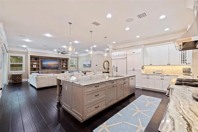 a view of a dining room with furniture and chandelier