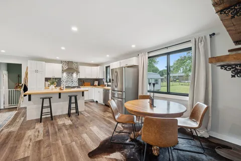 a view of a dining room with furniture window and outside view