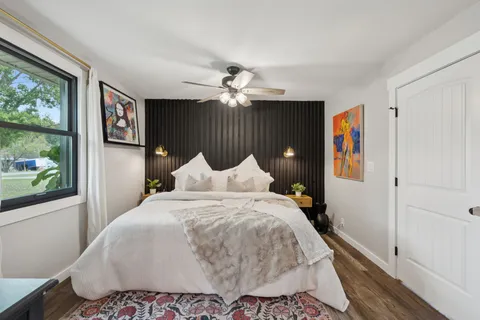 a bedroom with a large bed and a chandelier