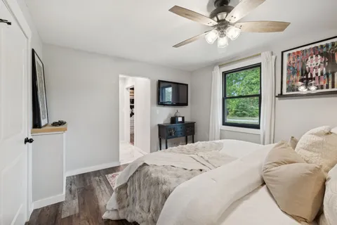 a spacious bedroom with a bed and a chandelier