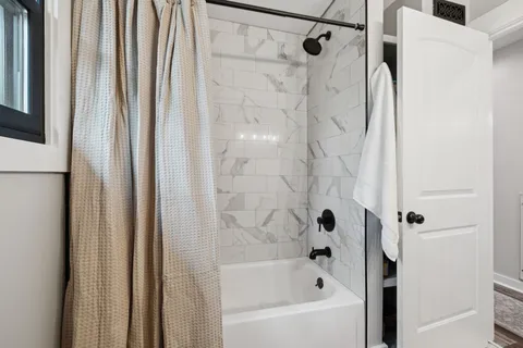 a bathroom with bathtub and a shower