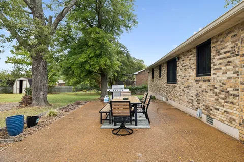 a view of a backyard with sitting area