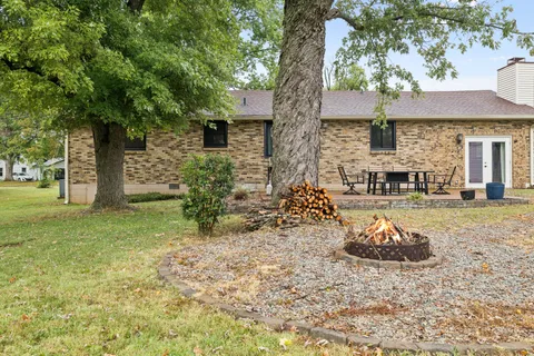 a view of a house with backyard of a house