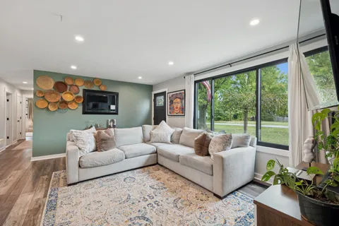 a living room with furniture and a large window