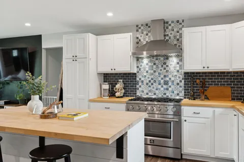 a kitchen with stainless steel appliances granite countertop a stove and a sink