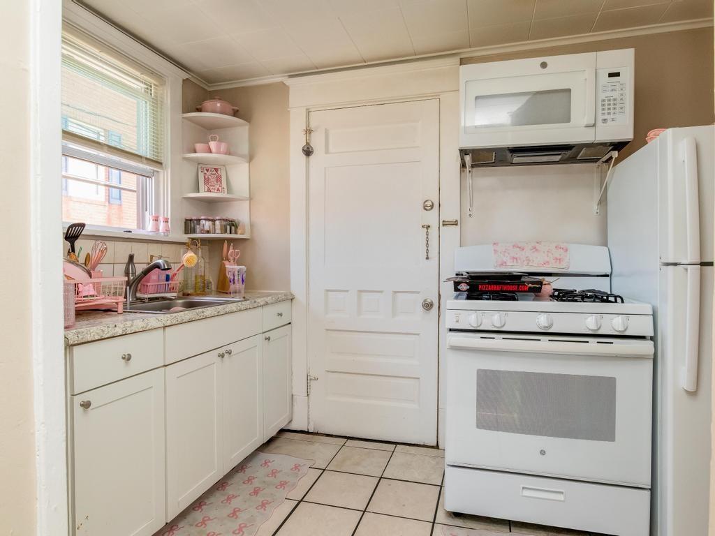282 9th Street Ambridge, PA 15003 - Photo 3 of 21 a kitchen with granite countertop white cabinets and white appliances