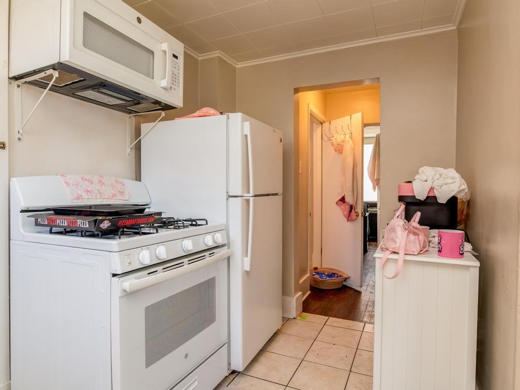 282 9th Street Ambridge, PA 15003 - Photo 5 of 21 a kitchen with a stove and a refrigerator