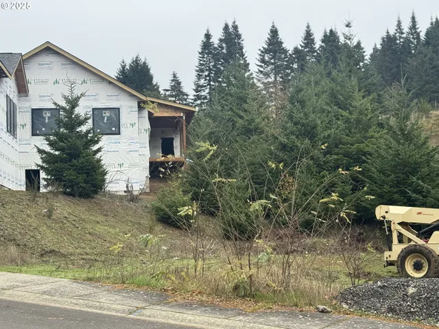 a view of a house with backyard and trees