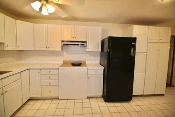 16 Wentworth Road Canton, MA 02021 - Photo 13 of 26 a kitchen with a refrigerator and cabinets