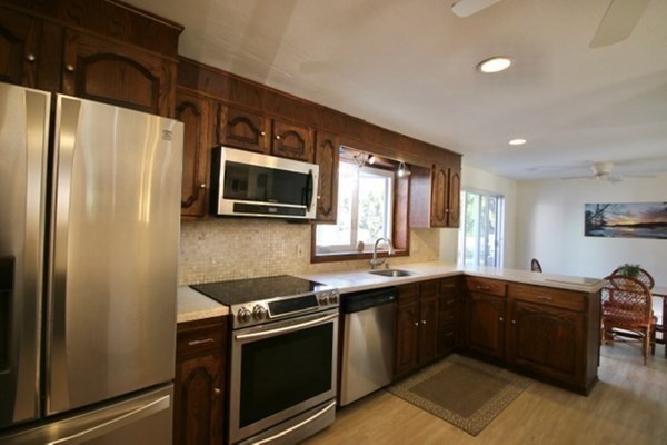 16 Wentworth Road Canton, MA 02021 - Photo 3 of 26 a kitchen with stainless steel appliances a sink stove and refrigerator