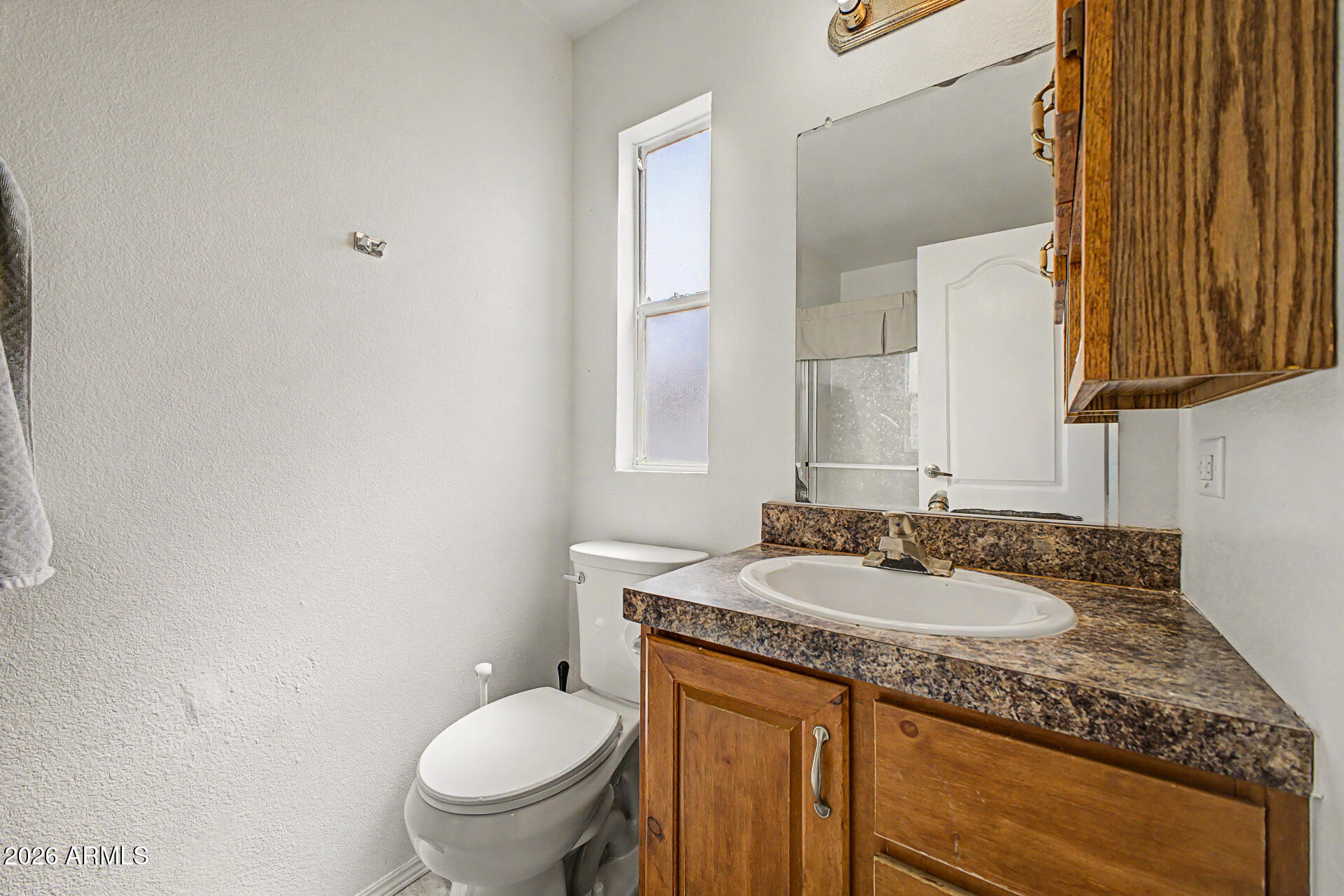 625 West McKellips Road, Unit 55 Mesa, AZ 85201 - Photo 15 of 21 a bathroom with a granite countertop sink toilet and mirror