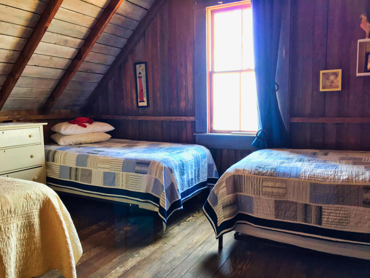 62 Corn Hill Road, Unit 6 Truro, MA 02666 - Photo 12 of 19 a bedroom with two beds and wooden walls