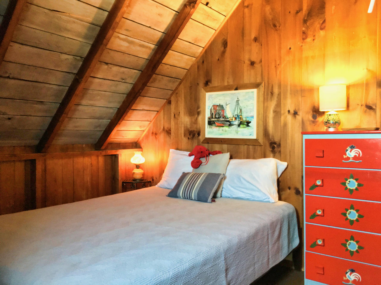 62 Corn Hill Road, Unit 6 Truro, MA 02666 - Photo 14 of 19 a bedroom with a bed and a painting on the wall