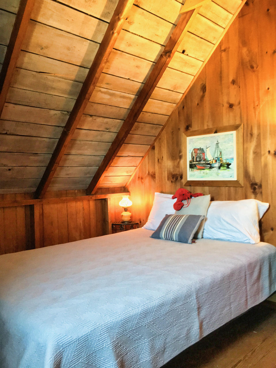 62 Corn Hill Road, Unit 6 Truro, MA 02666 - Photo 15 of 19 a bedroom with a bed and a large window