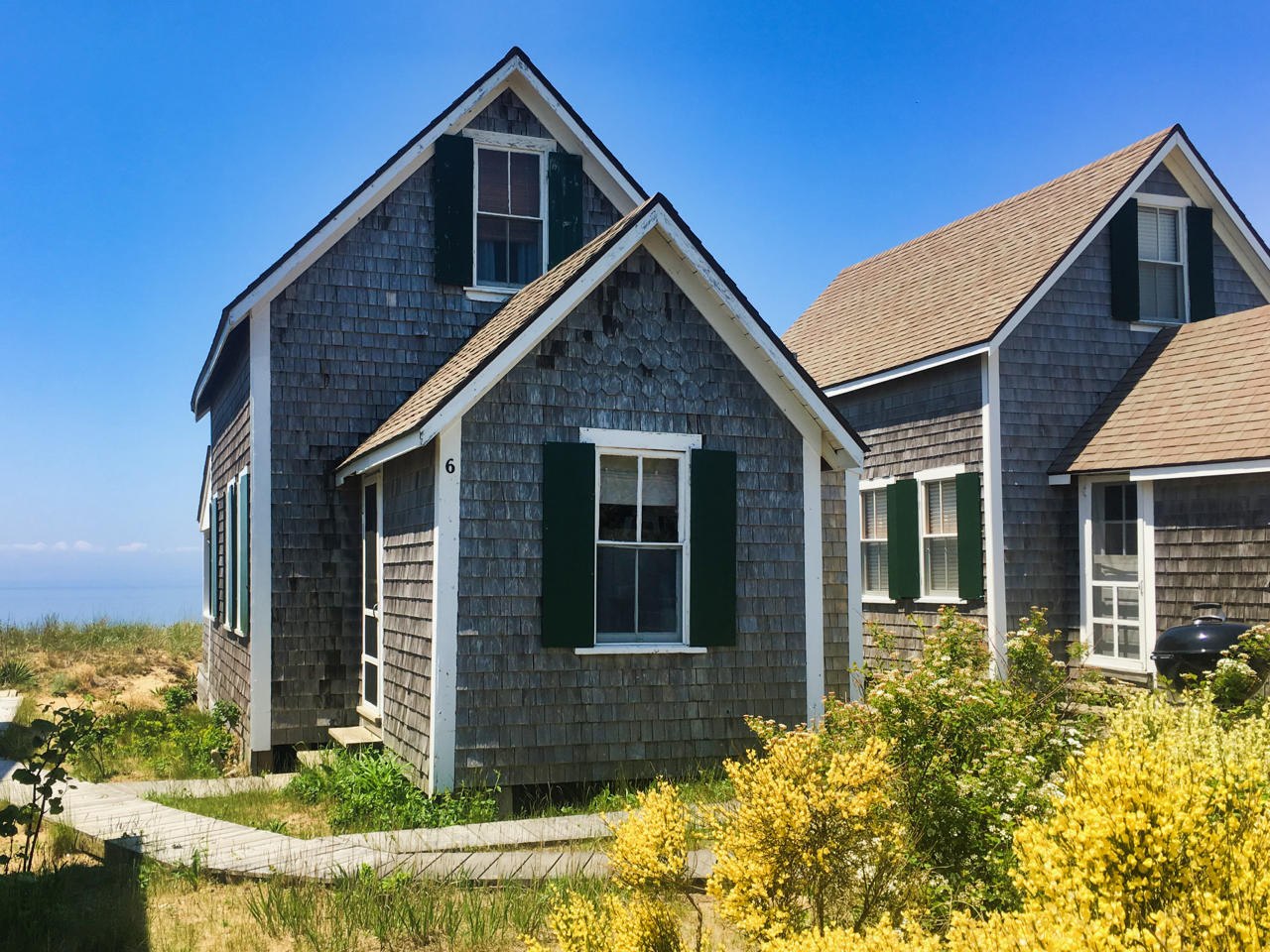 62 Corn Hill Road, Unit 6 Truro, MA 02666 - Photo 16 of 19 a front view of a house with garden