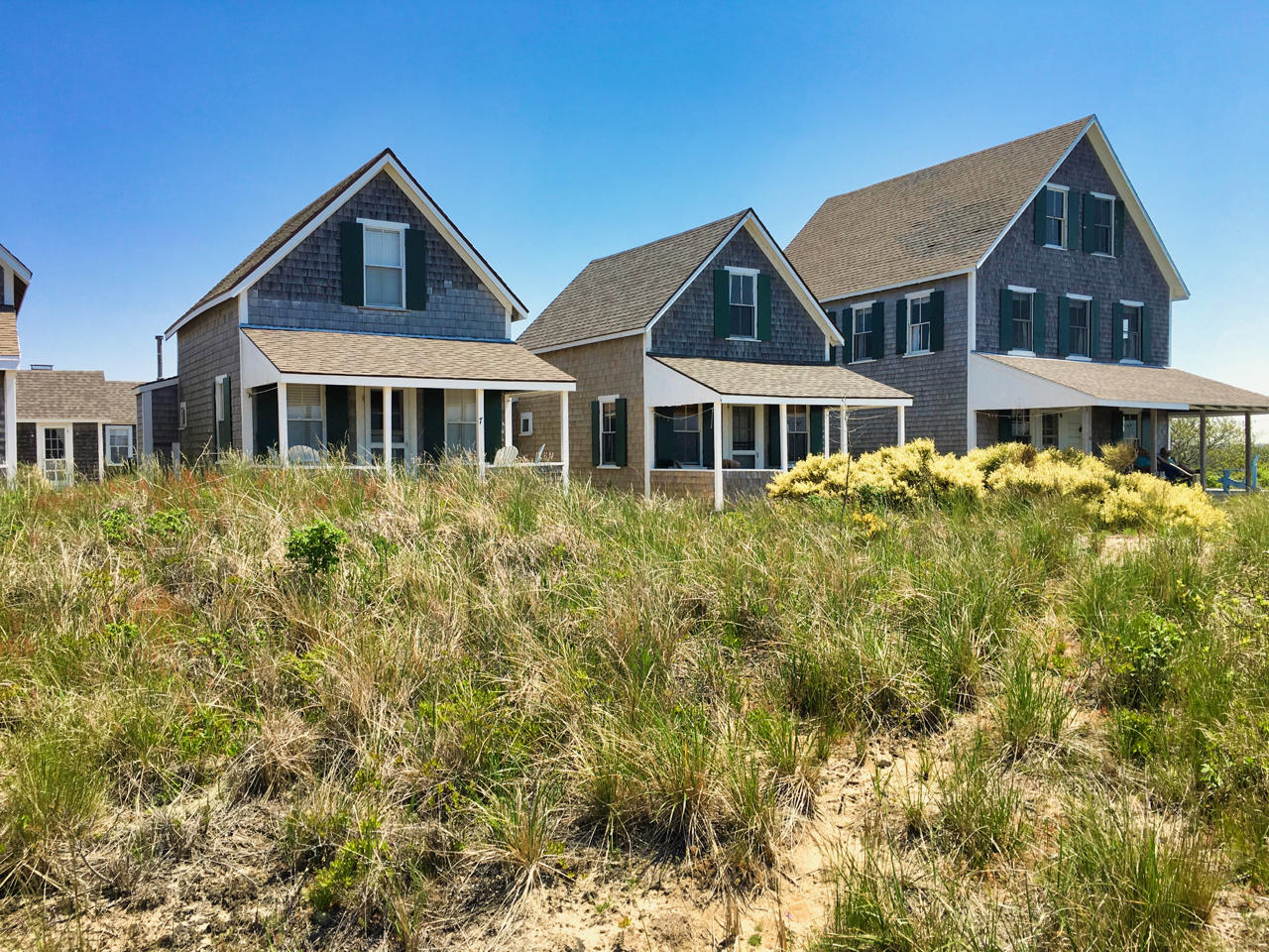 62 Corn Hill Road, Unit 6 Truro, MA 02666 - Photo 19 of 19 a front view of a house with a garden