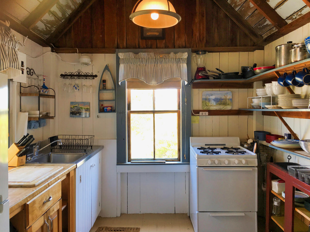 62 Corn Hill Road, Unit 6 Truro, MA 02666 - Photo 8 of 19 a kitchen with a stove and a sink