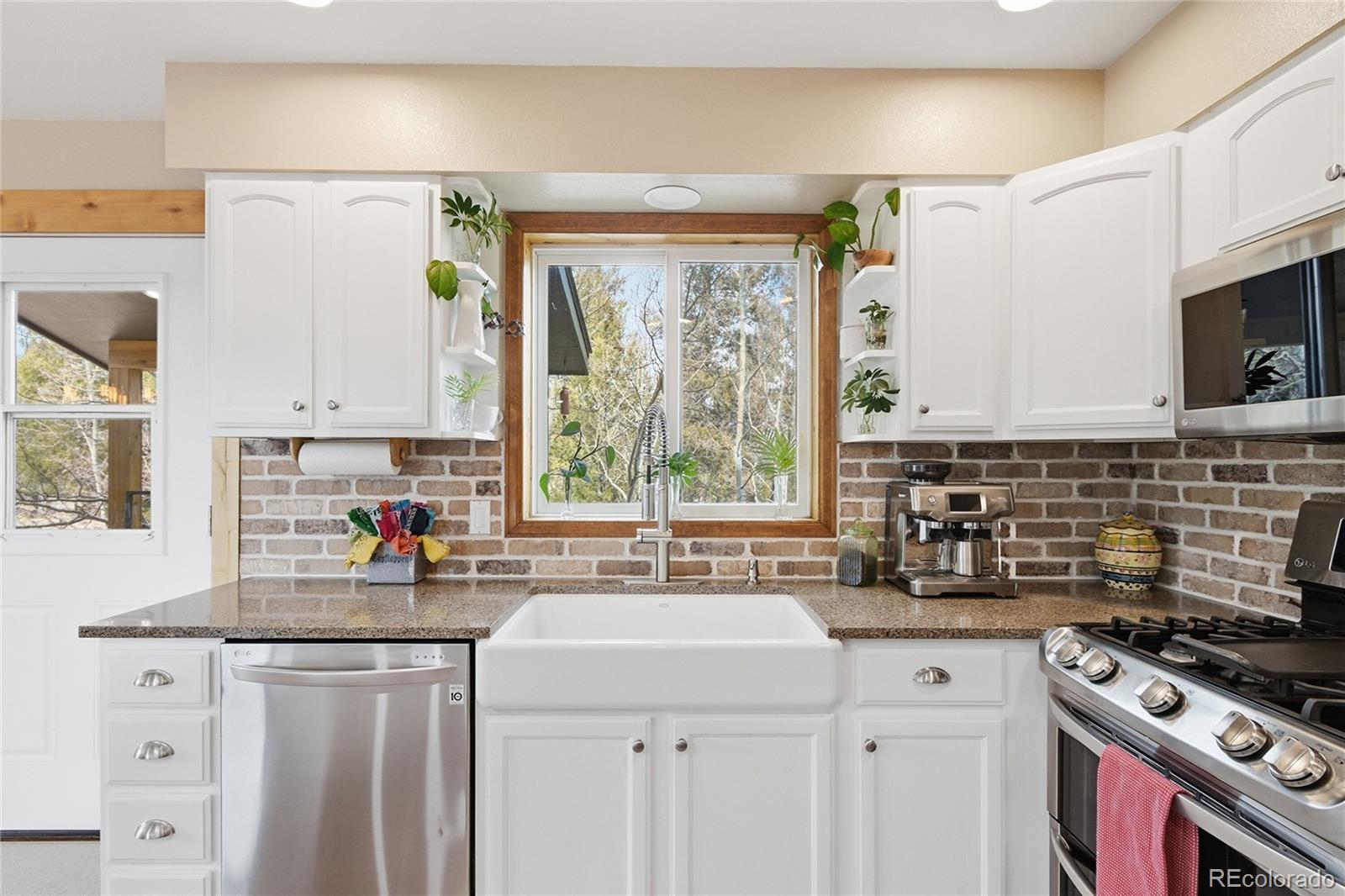 1146 Tapadero Road Bailey, CO 80421 - Photo 11 of 28 a kitchen with stainless steel appliances a sink stove and window