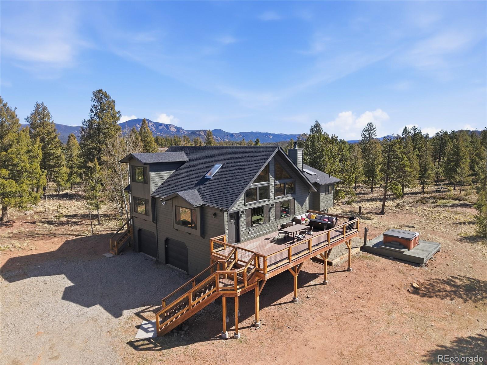 1146 Tapadero Road Bailey, CO 80421 - Photo 3 of 28 a view of a patio with a table and chairs