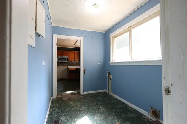 a view of a hallway with a window and a kitchen